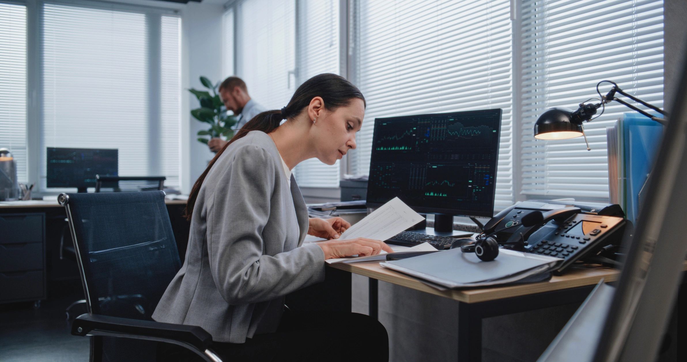 Analyst reviewing paper documents